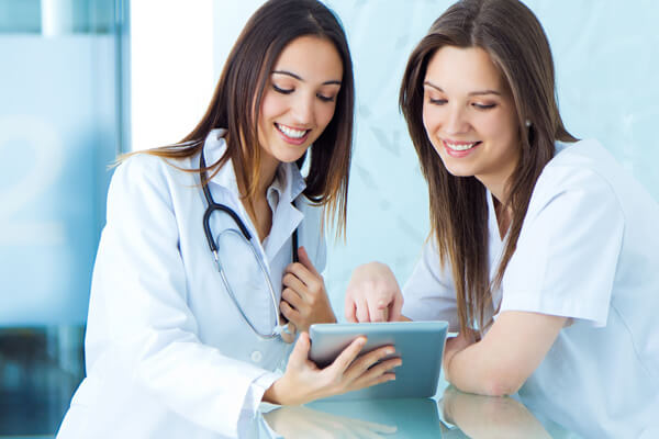 Hospital staff medical and nurse looking for something on a digital tablet at the hospital